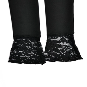 Detailed macro view showing the intricate black lace patchwork on the sleeve cuff of the top