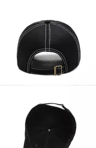Detail of black baseball cap showing vintage metal buckle and internal structure