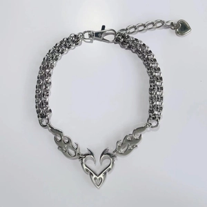Close-up of silver double-layer chain necklace with tribal flame heart pendant and clasp