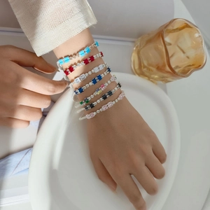 Close-up of luxury bracelet with multi-colored rectangular baguette-cut zirconia stones