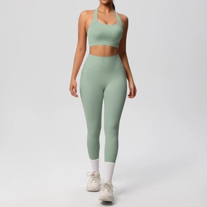 Detail showing side pocket on high-waist sage green yoga leggings with athletic sports bra