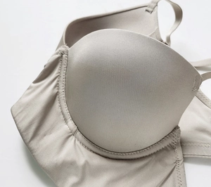 Detail shot of beige seamless ice silk bra featuring ribbed texture and push-up cup design
