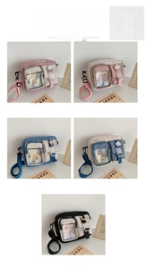 Detail view of colorful cartoon canvas crossbody bags with adjustable straps and badges