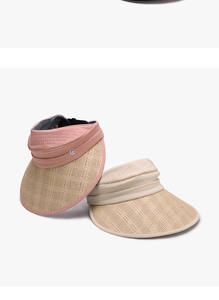 Close-up of pink and beige wide brim straw visors with pleated fabric detail
