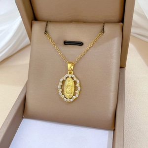 Close-up of gold oval Our Lady of Guadalupe pendant with sparkling cubic zirconia pavé