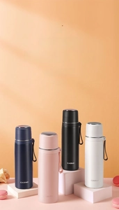 Multiple colors of 316 stainless steel insulated bottles with carry straps on display