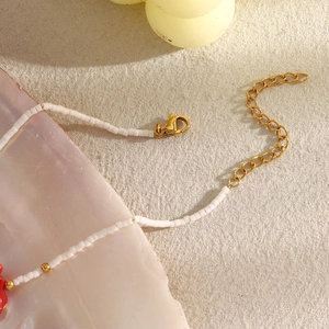 Detail of 18K gold plated beaded bracelet with starfish charms and lobster clasp