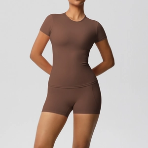 Detailed close-up of dark brown two-piece yoga set with high-waist shorts and short sleeve top