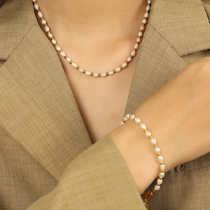 French vintage baroque pearl necklace and bracelet set shown on model in neutral suit