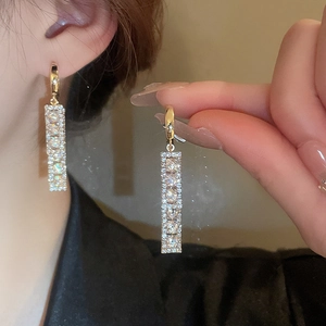 Elegant gold rectangle earrings with sparkling cubic zirconia on a minimalist base