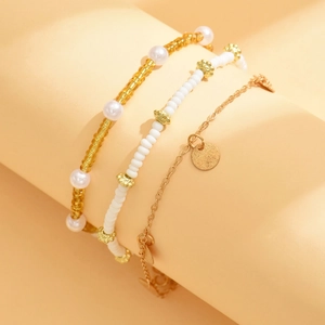 Three-piece bohemian anklet set with gold beads, faux pearls, and round metal pendants