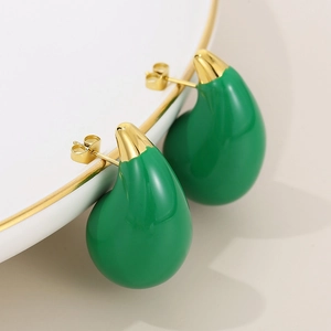 Detailed macro of teardrop earrings with green enamel and 18K gold stainless steel plating