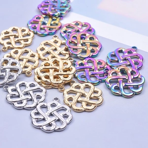 Macro detail of Celtic knot pendants in gold, silver and rainbow stainless steel finishes