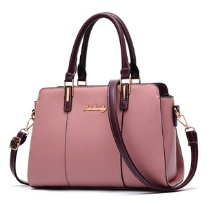 Pink and burgundy paneled faux leather tote bag with gold hardware and shoulder strap