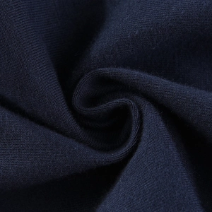 Micro shot of dark navy knitted girls' leggings fabric showing soft cotton texture