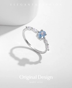 Macro view of S925 silver ring featuring blue oval crystal and marquise side stones
