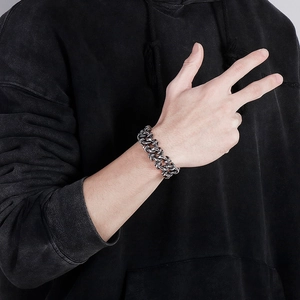 Close-up of heavy street punk style chunky silver chain bracelet on male wrist