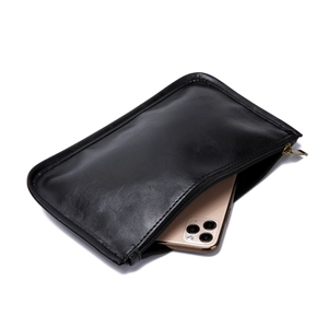 Détail du sac cabas en cuir vintage noir montrant sa capacité avec un smartphone doré