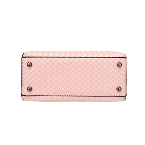 Detailed base view of pink woven leather handbag showing four protective metal feet