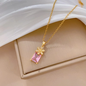 Macro shot of pink gemstone necklace with floral detail on elegant jewelry gift box
