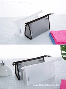 Detail of black and white mesh travel toiletry bags with top zippers and carry handles