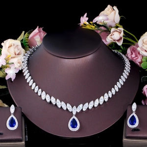 Detail of silver bridal jewelry set with navy blue teardrop stones and white zircon crystals
