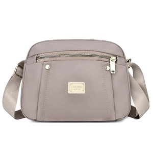 Fashionable grey nylon crossbody bag for women with wide strap and gold hardware