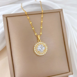 Close-up of luxury gold-plated titanium necklace with round zircon pendant on jewelry box