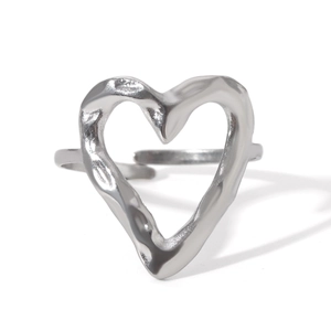 Macro shot of silver heart ring with unique hammered texture and adjustable open band