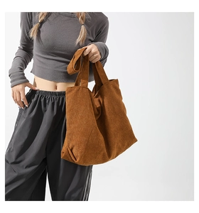 Brown corduroy tote bag showing large capacity and soft ribbed texture in use