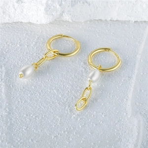 Elegant S925 silver gold hoop earrings with white teardrop pearls on a textured stone base