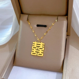 Titanium steel Xi character necklace in gold plating presented in a beige gift box