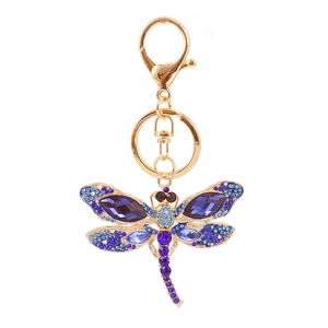 Golden dragonfly keychain with blue and purple crystals on a clean white background