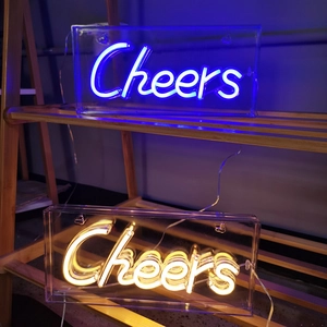 Close-up of blue and warm white LED Cheers neon signs on a wooden shelf for party decor