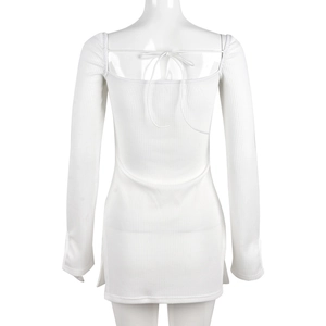 Detail of white waffle knit mini dress featuring an open back and criss-cross tie design