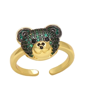 Detail of adjustable gold bear ring featuring green and black sparkling rhinestones