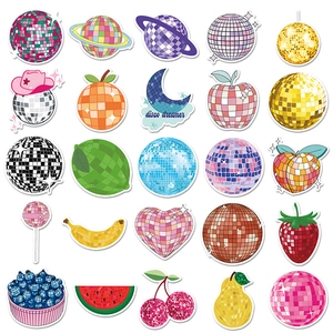Close-up of disco ball stickers in fruit and heart shapes with shiny mosaic patterns