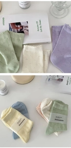 Detail of macaron color cotton socks featuring scalloped edges and hollow lace texture