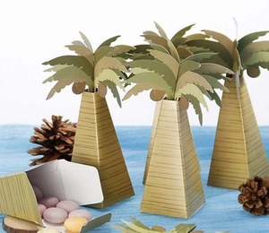 Creative palm tree shaped gift box with green leaves and colorful candy inside