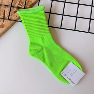 Detail of neon green cotton crew socks with ribbed texture and Empole brand label