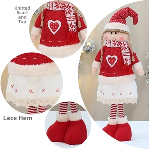Detail of knitted Christmas girl doll showing fabric texture, lace skirt and scarf