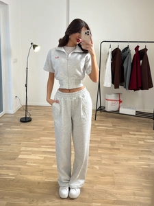 Light gray two-piece tracksuit featuring cropped zip polo top and high-waist joggers