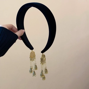 Ethnic style black velvet headband featuring golden metal tassels in a retro design