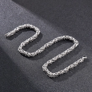 6mm silver Byzantine stainless steel chain with lobster clasp on dark background