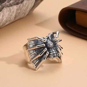 Macro detail of adjustable punk spider ring with silver vintage finish on a spider web