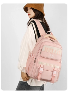 Pink nylon backpack with HELLO and smiley face print showing spacious storage details