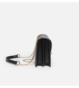 Side view of accordion-style chain bag with multi-layer structure and gold chain strap