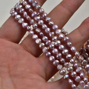 Macro shot of 4-5mm lavender baroque freshwater pearls strands for DIY jewelry