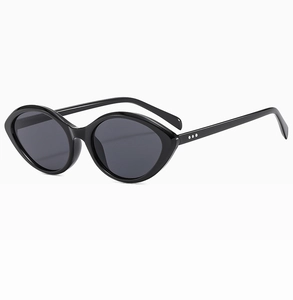 Detail view of vintage oval cat-eye sunglasses with triple silver rivets and black frame