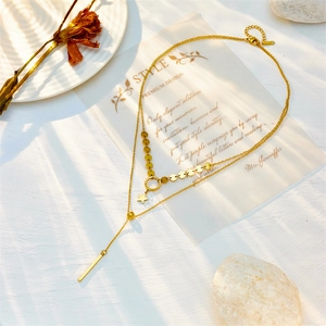 Double-layered gold titanium necklace featuring star pendant and elegant Y-shape tassels